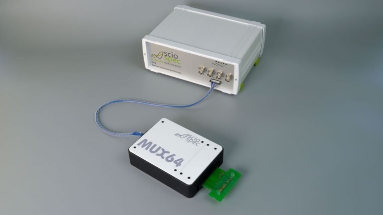 Sciospec ISX-3 impedance analyzer connected to a multiplexing (MUX) module with multiple ports, enabling simultaneous or sequential measurements of multiple DNA samples for high-throughput testing.