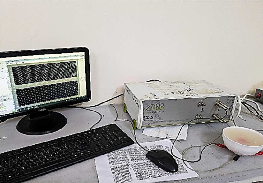 Experimental setup with Sciospec ISX-5 multi-frequency impedance analyzer used for measuring impedance values in breast cancer tissue models.