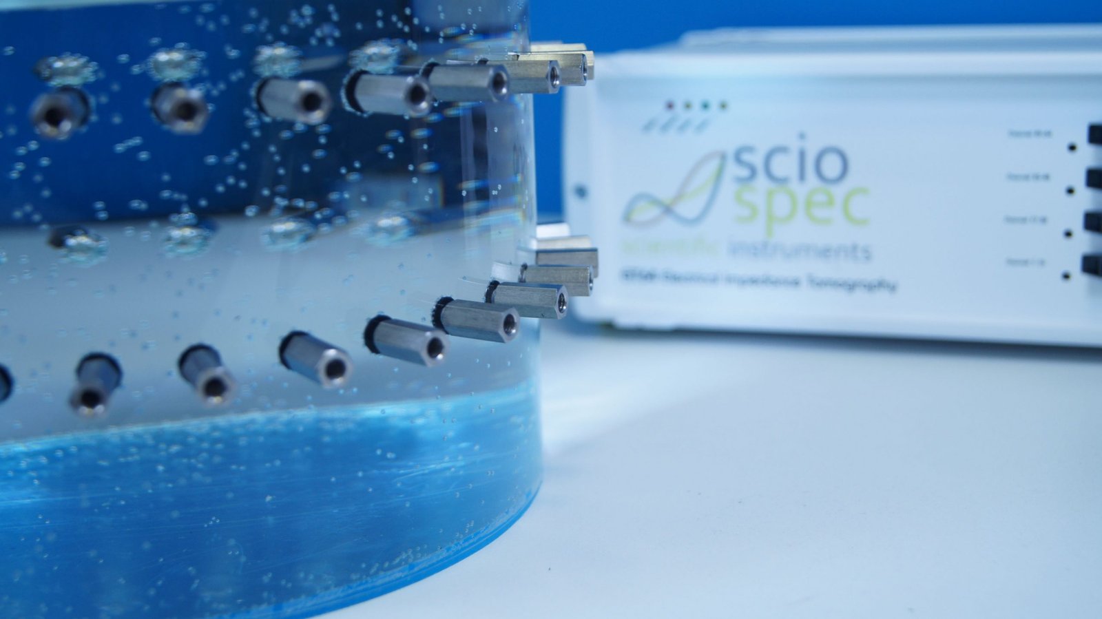 An Electrical Impedance Tomography (EIT) device connected to a phantom tank, used for high-precision impedance measurements in biomedical and technological research.