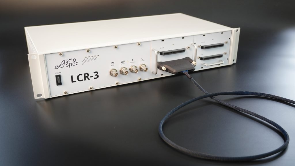 Sciospec LCR-3 device in modular desktop or rack-mountable enclosure, ideal for lab and production environments.