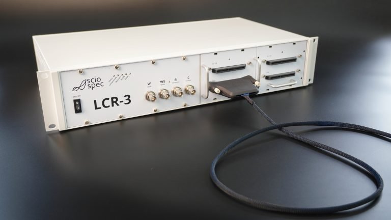Sciospec LCR-3 device in modular desktop or rack-mountable enclosure, ideal for lab and production environments.
