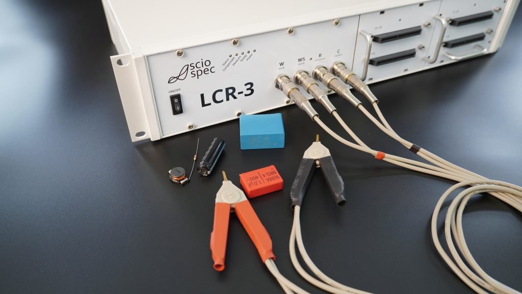 Screenshot of the Sciospec LCR measurement app showing live data visualization, test setup, and pass/fail metrics.